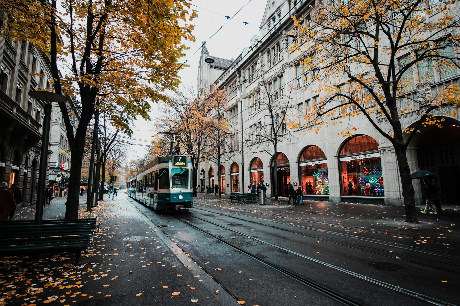 pexels-photo-773471-773471 A tram travels down a leaf-strewn street in autumnal Zürich, Switzerland's urban landscape.